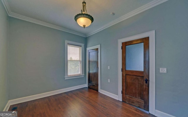 unfurnished room featuring ornamental molding and dark hardwood / wood-style flooring