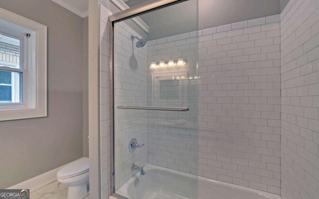 bathroom with tile floors, toilet, enclosed tub / shower combo, and ornamental molding