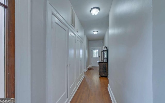 corridor with wood-type flooring