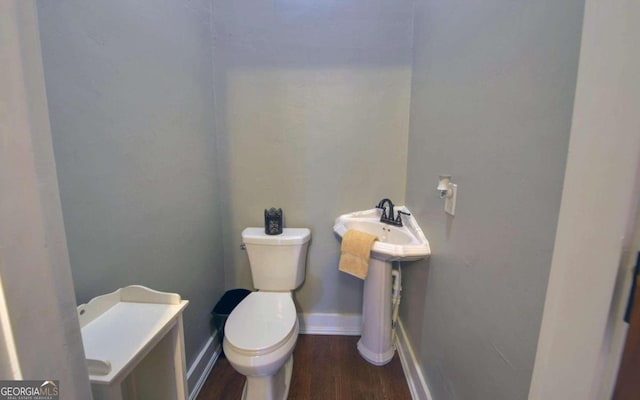 bathroom featuring hardwood / wood-style floors and toilet