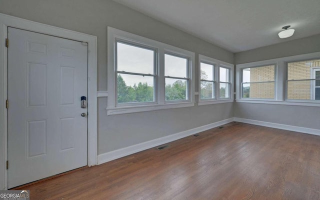 unfurnished sunroom featuring a wealth of natural light