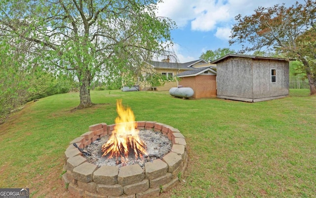 view of yard with an outdoor fire pit