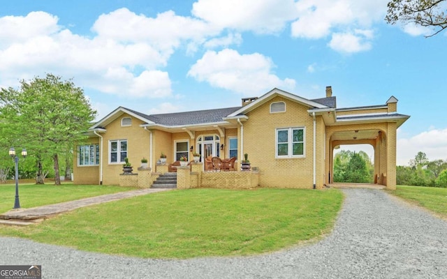 ranch-style home featuring a carport and a front yard