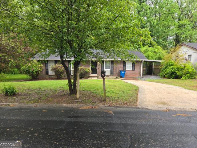 ranch-style home with a front lawn