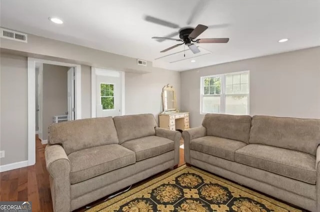 living room with plenty of natural light, wood-type flooring, and ceiling fan