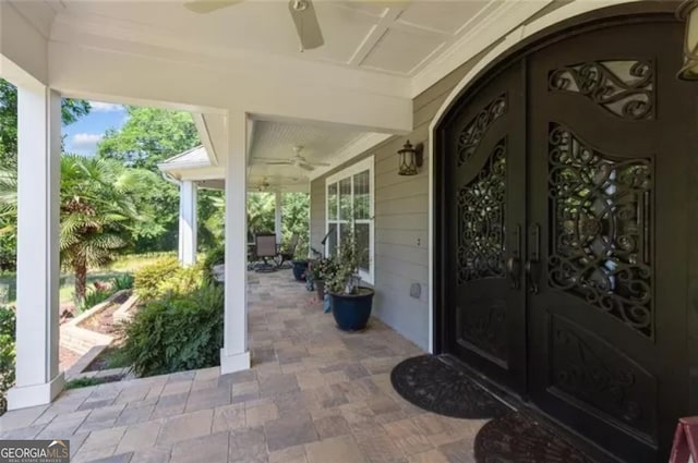 doorway to property featuring ceiling fan