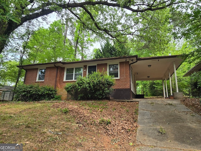 ranch-style home with a carport and a storage shed