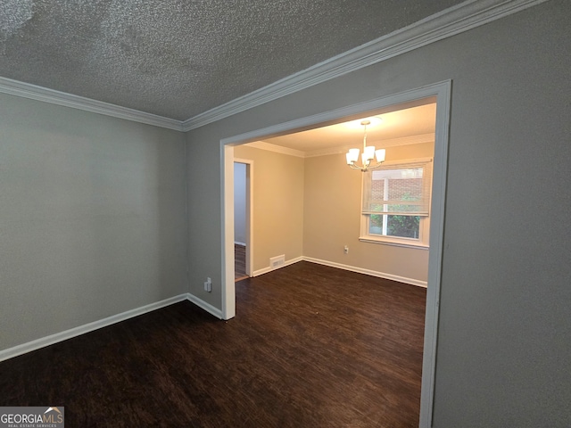 empty room with ornamental molding, a textured ceiling, dark hardwood / wood-style flooring, and a notable chandelier