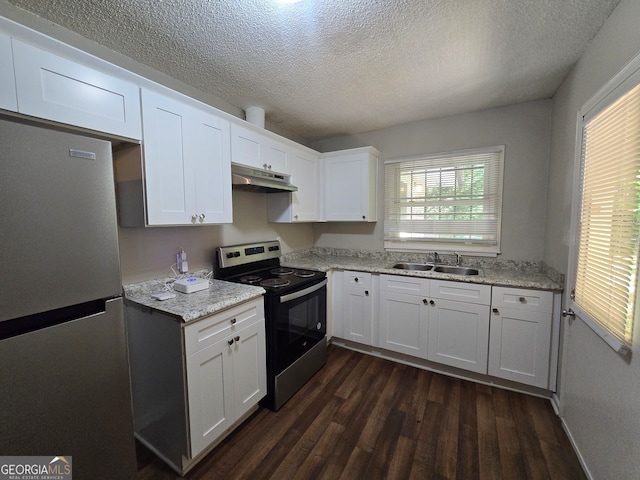 kitchen with appliances with stainless steel finishes, a textured ceiling, sink, white cabinetry, and dark hardwood / wood-style floors