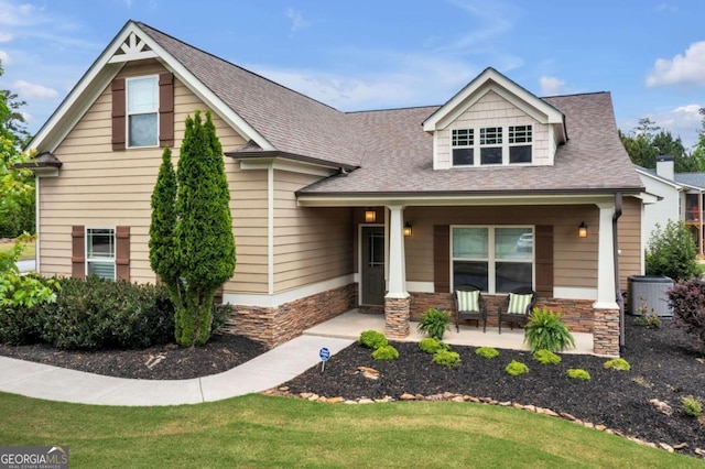 view of front of home with covered porch and a front yard