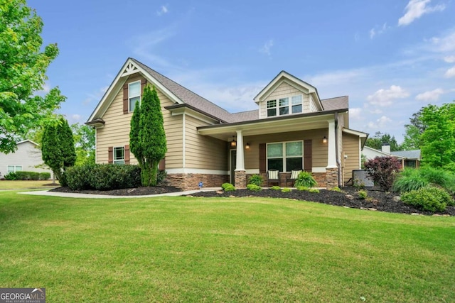 craftsman-style house featuring covered porch and a front yard