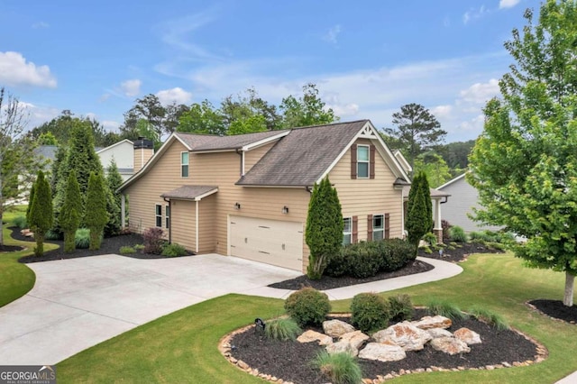 view of front of house featuring a front yard and a garage