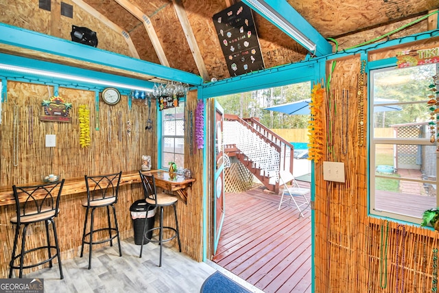 entryway with vaulted ceiling and wood-type flooring