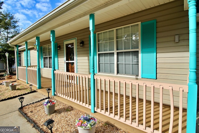 view of front of home featuring a garage, a porch, and a front lawn