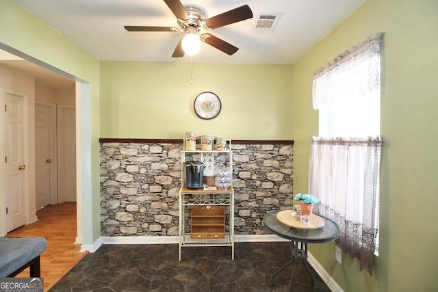 sitting room featuring tile floors and ceiling fan