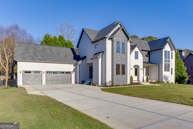 view of front of property with a front yard and a garage