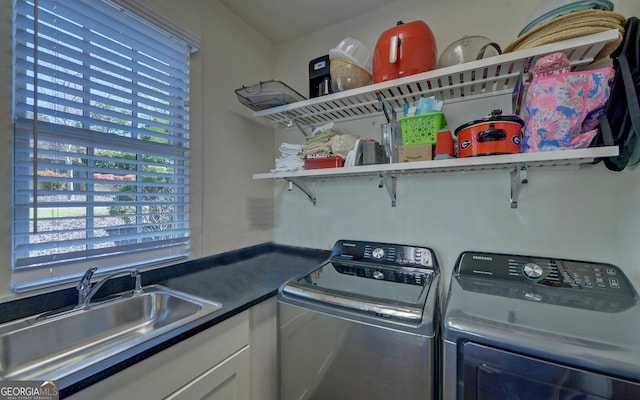 laundry room featuring sink, cabinets, and separate washer and dryer