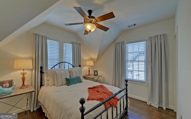 bedroom with ceiling fan, vaulted ceiling, and dark hardwood / wood-style floors