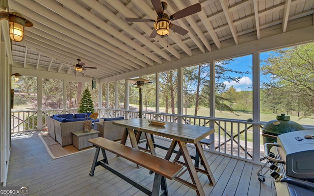 sunroom / solarium featuring lofted ceiling and ceiling fan