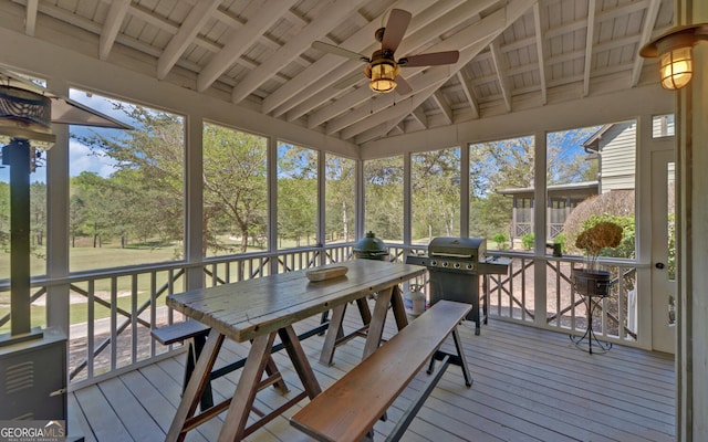 sunroom featuring lofted ceiling with beams and ceiling fan