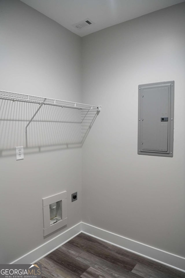 laundry room with electric panel, dark wood-type flooring, and electric dryer hookup