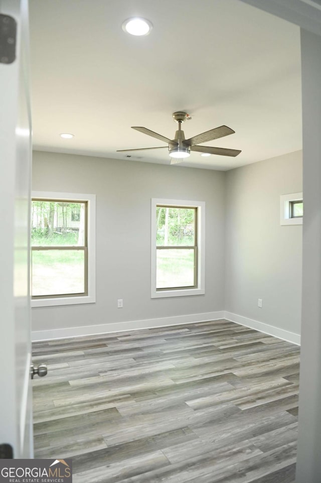 unfurnished room featuring light hardwood / wood-style flooring and ceiling fan