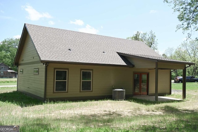 rear view of house with french doors and cooling unit