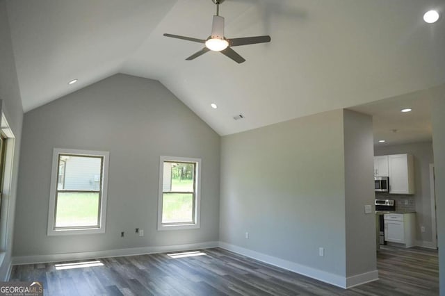 unfurnished living room with ceiling fan, dark hardwood / wood-style floors, and vaulted ceiling