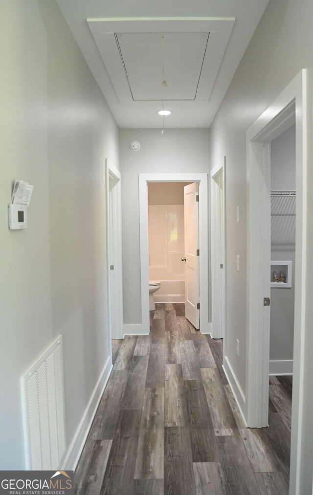 hall with dark wood-type flooring