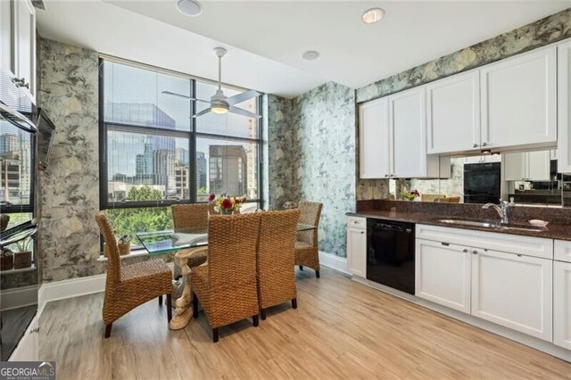 kitchen featuring sink, black dishwasher, a healthy amount of sunlight, and light hardwood / wood-style floors