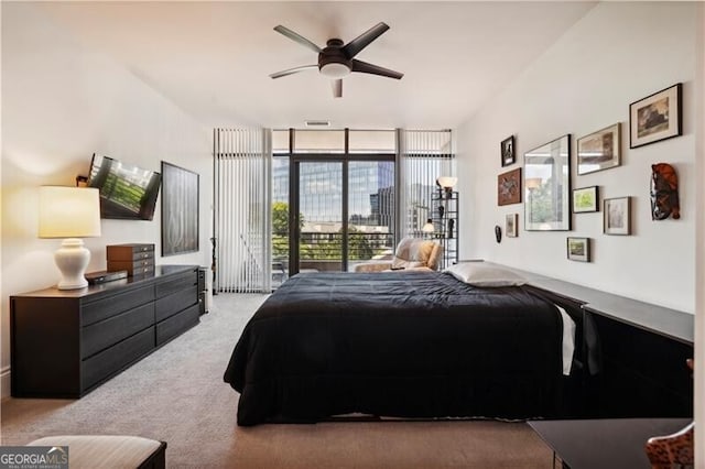 bedroom featuring access to outside, light colored carpet, ceiling fan, and a wall of windows