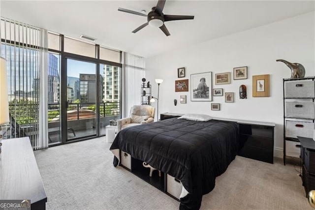 bedroom featuring light colored carpet, floor to ceiling windows, ceiling fan, and access to outside