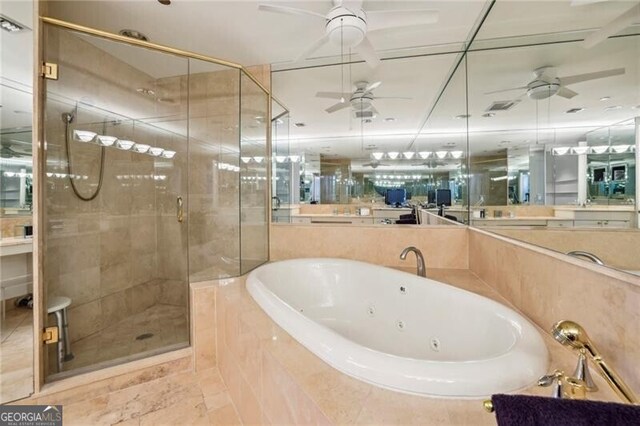 bathroom with plus walk in shower, ceiling fan, vanity, and tile flooring