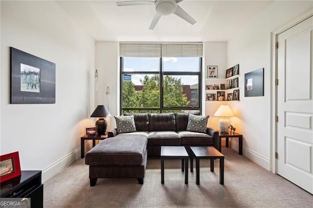 sitting room with ceiling fan and carpet floors