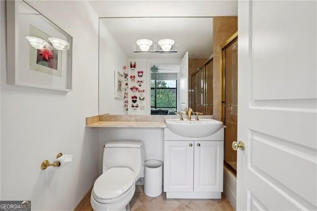 full bathroom with vanity, tile floors, toilet, and bath / shower combo with glass door