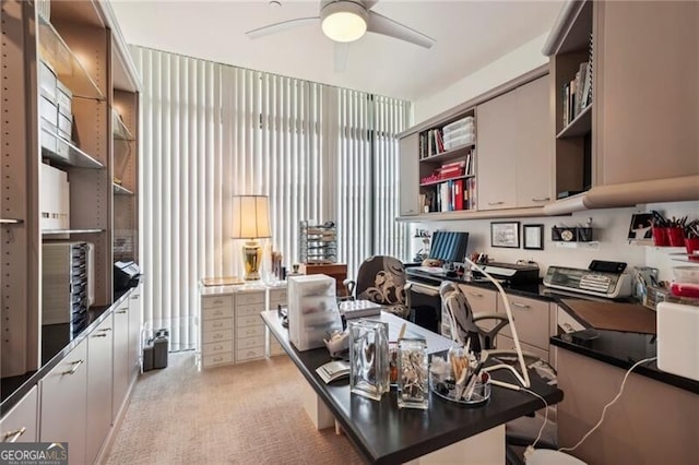 office featuring ceiling fan and light carpet