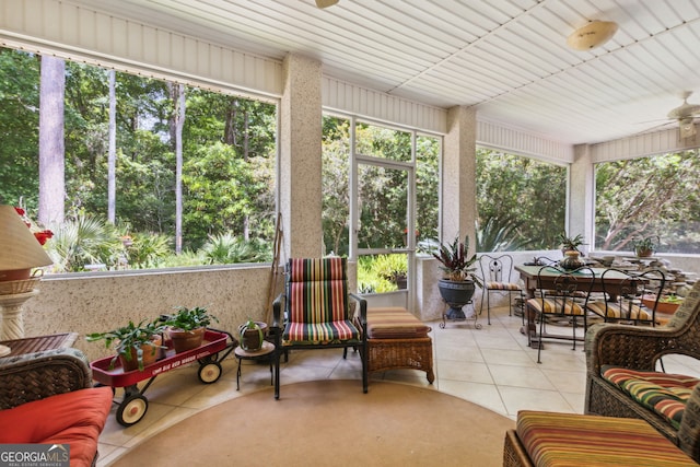 sunroom featuring ceiling fan