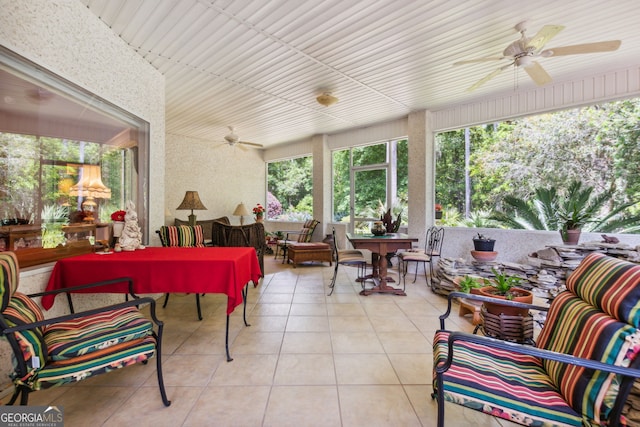 sunroom / solarium featuring ceiling fan