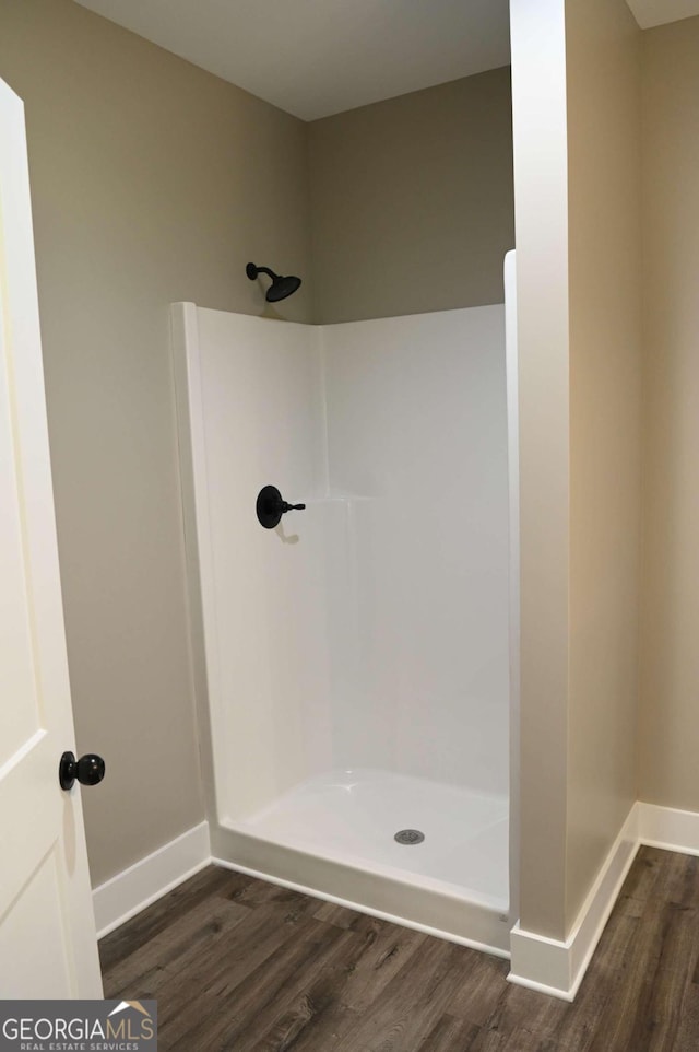 bathroom featuring a shower and hardwood / wood-style floors