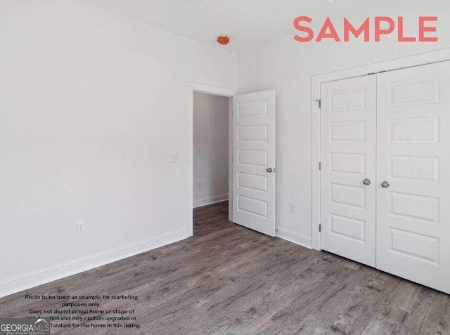 unfurnished bedroom featuring dark hardwood / wood-style floors