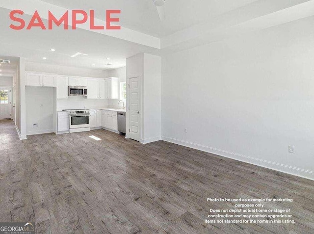 unfurnished living room featuring dark hardwood / wood-style flooring and sink