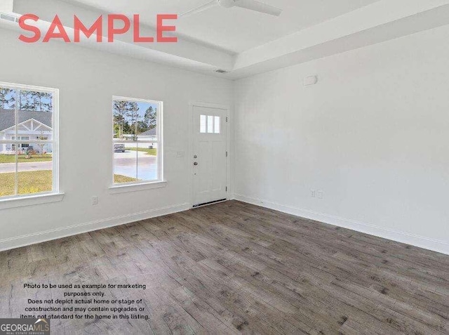 unfurnished room with ceiling fan and dark wood-type flooring