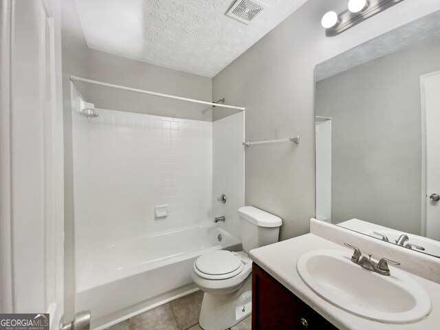 full bathroom featuring bathing tub / shower combination, toilet, a textured ceiling, vanity, and tile floors