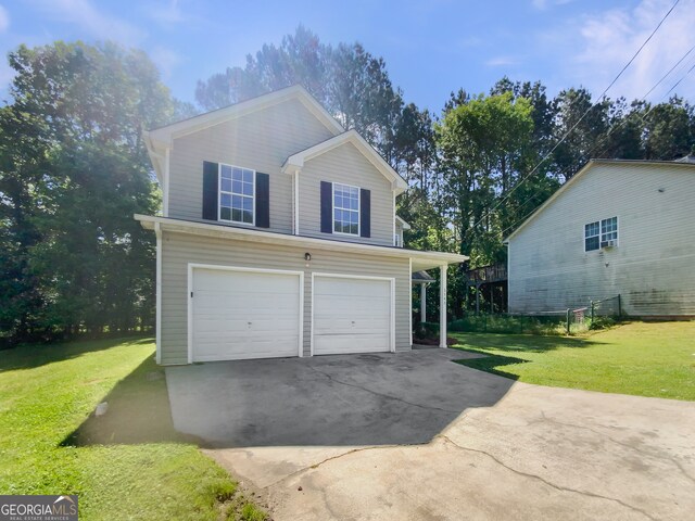 view of front facade with a front yard and a garage