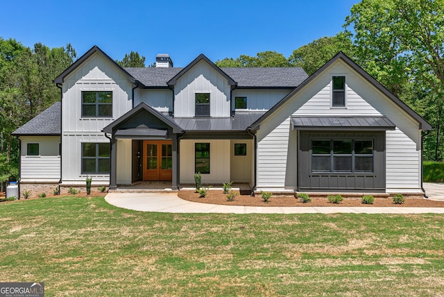 modern inspired farmhouse with covered porch and a front lawn