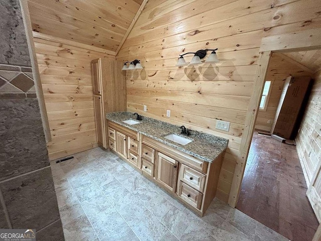 bathroom with wood walls, double sink vanity, lofted ceiling, wood ceiling, and tile floors