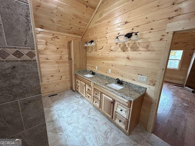 bathroom featuring wood walls, vanity, wooden ceiling, tile flooring, and vaulted ceiling