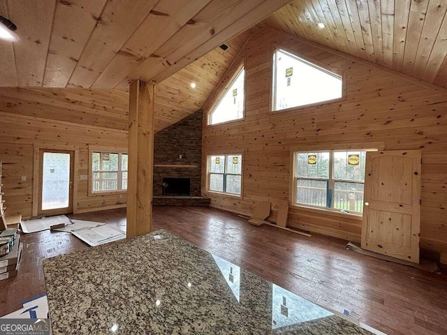 bonus room with wood walls, hardwood / wood-style floors, wooden ceiling, and a fireplace