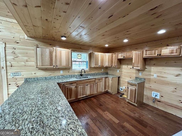 kitchen featuring wooden walls, light stone countertops, dark hardwood / wood-style flooring, sink, and wood ceiling