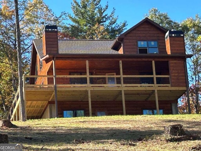 back of house featuring a wooden deck